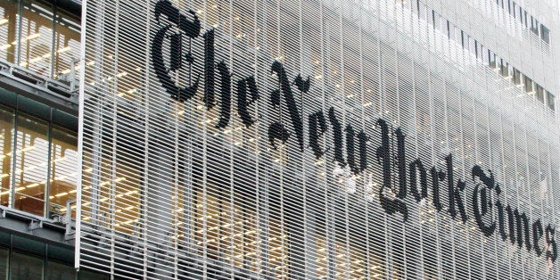 People pass the New York Times building in New York, Wednesday, Oct. 10, 2012. The New York Times Co.'s stock rose on Thursday, Oct. 11, 2012, after an analyst raised his rating and price target on the shares. (AP Photo/Richard Drew)