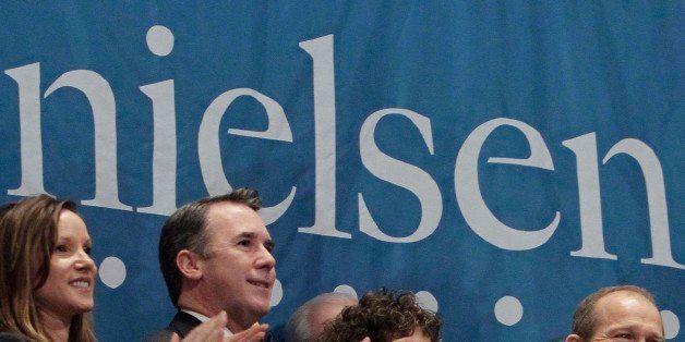 Nielsen Company CEO David Calhoun, second from right, applauds with company officials during opening bell ceremonies for the Nielsen IPO, at the New York Stock Exchange, Wednesday, Jan. 26, 2011. (AP Photo/Richard Drew)