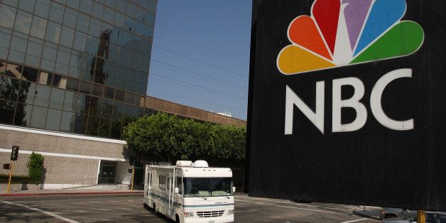 BURBANK, CA - OCTOBER 20: The NBC peacock logo hangs on the NBC studios building as a mobile home is parked nearby on October 20, 2008 in Burbank, California. NBC Universal plans another round of major cuts totaling $500 million from the next yearly budget in spite of recent strong quarterly reports. The cuts come as the media sector copes with recent market turmoil that sent stock prices for many major conglomerates plunging to all-time lows, as much as 70 percent for the past year. NBC Universal stations are facing a serious local ad slump while its parent company, General Electric, is facing financial problems with heavy reliance on financial services in an environment of frozen credit. (Photo by David McNew/Getty Images)
