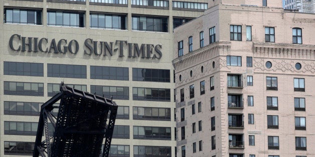 The Chicago Sun Times building is photographed Thursday, May 30, 2013, in Chicago. The Sun-Times Media announced today that they laid off their entire full time photography staff at the city's tabloid newspaper, and its suburban sister publications. The union representing laid-off photographers at the Chicago Sun-Times plans to file a bad-faith bargaining charge with the National Labor Relations Board. (AP Photo/M. Spencer Green)