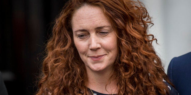LONDON, ENGLAND - JUNE 26: Former News International chief executive Rebekah Brooks and her husband Charlie Brooks give a sta