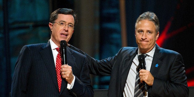 FILE - In this Oct. 2, 2010 file photo, Stephen Colbert, left, and Jon Stewart appear on stage at Comedy Central's 'Night Of Too Many Stars: An Overbooked Concert For Autism Education' at the Beacon Theatre in New York. (AP Photo/Charles Sykes)