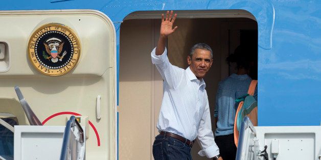 President Barack Obama waves as he boards Air Force One with his daughter Malia Obama at Andrews Air Force Base, Md., Tuesday, Aug. 19, 2014, en route to return to the Obama family vacation on the Massachusetts island of Martha's Vineyard, after the president briefly returned to Washington to attend meetings. (AP Photo/Manuel Balce Ceneta)