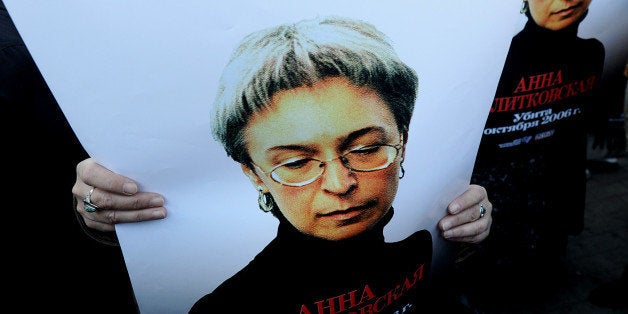 Russian human rights activists attend a rally in honour of slain Russian journalist Anna Politkovskaya in Moscow on October 7, 2010. The Russian investigative journalist, known for her critical coverage of the war in Chechnya, was found murdered on October 7, 2006 in the hallway of the building where she lived in Moscow. AFP PHOTO / NATALIA KOLESNIKOVA (Photo credit should read NATALIA KOLESNIKOVA/AFP/Getty Images)