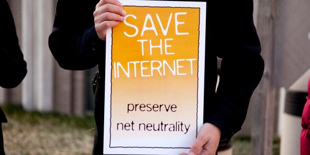 Timothy Karr of the Free Press holds a sign in support of net-neutrality before a hearing at the U.S. Federal Communications Commission in Washington, D.C., U.S., on Tuesday, Dec. 21, 2010. U.S. regulators banned Internet service providers led by AT&T Inc. and Comcast Corp. from blocking or slowing Web content sent to homes and businesses, while allowing mobile phone companies to put limits on traffic. Photographer: Andrew Harrer/Bloomberg via Getty Images