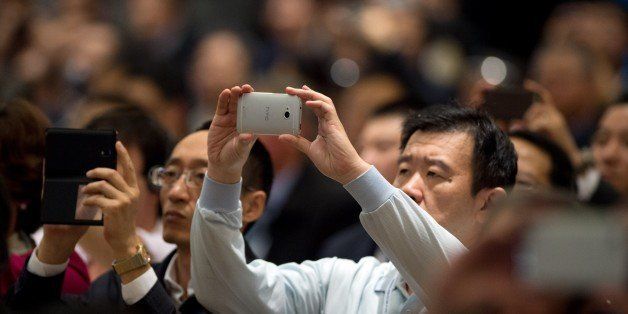 Visitors use their smartphones to record a speech by Jack Ma (not pictured), founder of e-commerce giant Alibaba which recently listed on the New York Stock Exchange, as he speaks at the opening ceremony of the World Internet Conference in Wuzhen, in eastern China's Zhejiang province on November 19, 2014. China, which censors online content it deems to be politically sensitive, opened the World Internet Conference in Wuzhen with the country's biggest Internet companies in attendance alongside a sprinkling of foreign executives and officials. AFP PHOTO / JOHANNES EISELE [IN_PRODUCTION] [VerrouillÃÂ©]12:57-19/11/2014WuzhenSHAECO,POL (Photo credit should read JOHANNES EISELE/AFP/Getty Images)