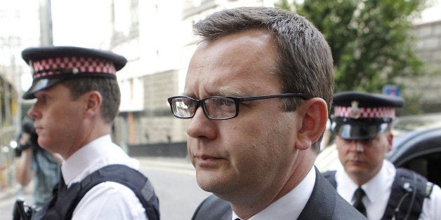 Andy Coulson, (C) a former top aide to British Prime Minister David Cameron, arrives at the Old Bailey in central London, ahead of his expected sentencing in the phone-hacking trial, on July 4, 2014. Andy Coulson, a former top aide to British Prime Minister David Cameron, and four ex-colleagues of the former newspaper editor will be sentenced by a judge at London's Old Bailey court over the industrial-scale hacking of the voicemails of thousands of people including royals, celebrities and politicians. AFP PHOTO / CYRIL VILLEMAIN (Photo credit should read CYRIL VILLEMAIN/AFP/Getty Images)