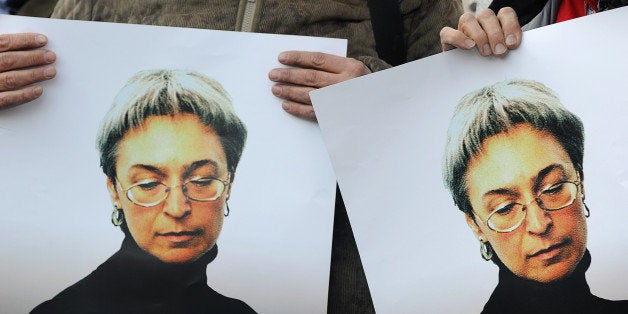 Russian human rights activists attend a rally in honour of slain Russian journalist Anna Politkovskaya in Moscow on October 7
