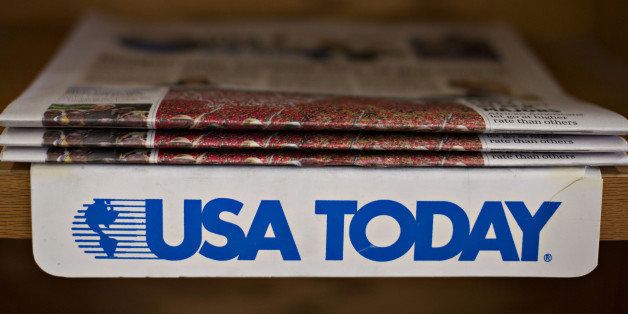 Copies of the USA Today newspaper sit on display for sale at a newsstand in Princeton, Illinois, U.S., on Tuesday, Aug. 5, 2014. Gannett Co., the owner of USA Today, has agreed to buy out the other companies that own Cars.com for $1.8 billion, according to a person familiar with the matter. Photographer: Daniel Acker/Bloomberg via Getty Images