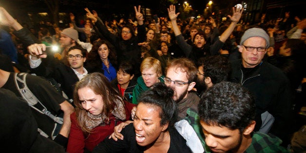 BERKELEY, CA - DECEMBER 7: Demonstrators react as they were being push by by the police on Telegraph Ave during a demonstration over recent grand jury decisions in police-involved deaths on December 7, 2014 in Berkeley, California. A Staten Island, New York grand jury declined on Wednesday to indict New York City Police Officer Daniel Pantaleo in the chokehold death of Eric Garner. (Photo by Stephen Lam/Getty Images)