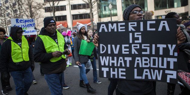 WASHINGTON, D.C. - DECEMBER 13: People gather to protest against police violence during the national march after two grand juries decided not to indict the police officers involved in the deaths of Michael Brown in Ferguson, Mo. and Eric Garner in New York, on December 13, 2014, in Washington, D.C. (Photo by Samuel Corum/Anadolu Agency/Getty Images)