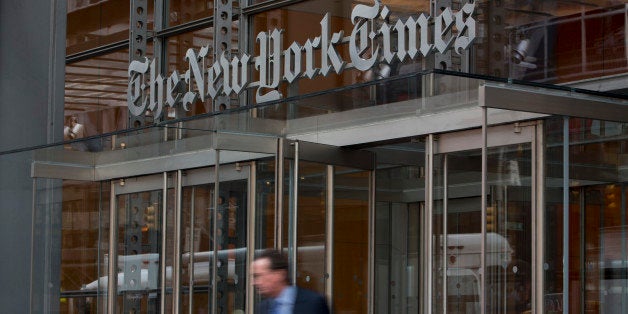 A pedestrian passes in front of The New York Times Co. offices in New York, U.S., on Wednesday, July 31, 2013. The New York Times Co. is scheduled to release earnings data on Aug. 1. Photographer: Scott Eells/Bloomberg via Getty Images