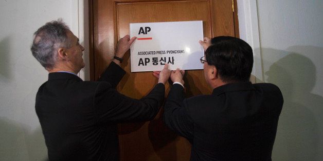 Associated Press President Tom Curley, left, and Korean Central News Agency President Kim Pyong Ho hang the Associated Press Pyongyang sign on the door to open a new AP bureau in Pyongyang, North Korea on Monday Jan. 16, 2012. The AP opened its newest bureau in North Korea, making it the first international news organization with a full time presence to cover news from North Korea in words, pictures, and video. (AP Photo/David Guttenfelder)