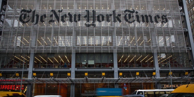 NEW YORK, NY - OCTOBER 01: Traffic drives past The New York Times building on October 1, 2014 in New York City. The Times announced plans to cut approximately 100 jobs from the newsroom today, with the company announcing it will start with buy-out packages before moving to layoffs. (Photo by Andrew Burton/Getty Images)