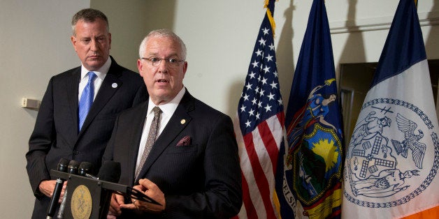 New York City Mayor Bill de Blasio, left, watches as John Miller, deputy commissioner of intelligence and counterterrorism of the NYPD, speaks to reporters during a news conference following a meeting at the White House in Washington, Tuesday, Oct. 14, 2014. (AP Photo/Manuel Balce Ceneta)