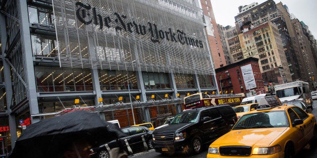 NEW YORK, NY - OCTOBER 01: People walk past The New York Times building on October 1, 2014 in New York City. The Times announced plans to cut approximately 100 jobs from the newsroom today, with the company announcing it will start with buy-out packages before moving to layoffs. (Photo by Andrew Burton/Getty Images)