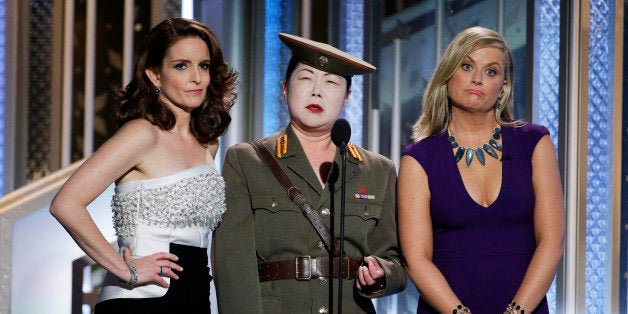 BEVERLY HILLS, CA - JANUARY 11: In this handout photo provided by NBCUniversal, Tina Fey, Margaret Cho and Amy Poehler speak onstage during the 72nd Annual Golden Globe Awards at The Beverly Hilton Hotel on January 11, 2015 in Beverly Hills, California. (Photo by Paul Drinkwater/NBCUniversal via Getty Images)