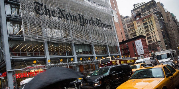 NEW YORK, NY - OCTOBER 01: People walk past The New York Times building on October 1, 2014 in New York City. The Times announced plans to cut approximately 100 jobs from the newsroom today, with the company announcing it will start with buy-out packages before moving to layoffs. (Photo by Andrew Burton/Getty Images)