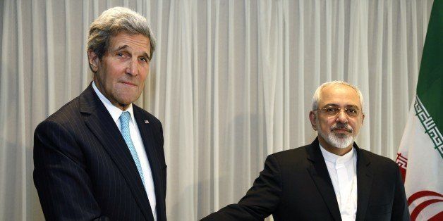 Iranian Foreign Minister Mohammad Javad Zarif shakes hands on January 14, 2015 with US State Secretary John Kerry in Geneva. Zarif said on January 14 that his meeting with his US counterpart was vital for progress on talks on Tehran's contested nuclear drive. Under an interim deal agreed in November 2013, Iran's stock of fissile material has been diluted from 20 percent enriched uranium to five percent, in exchange for limited sanctions relief. AFP PHOTO / POOL / RICK WILKING (Photo credit should read RICK WILKING/AFP/Getty Images)