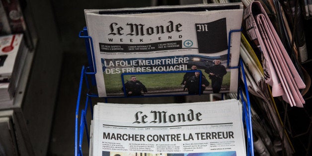 PARIS, FRANCE - JANUARY 10: A copy of 'Le Monde' and the 'Courier International' with front page reports on this weeks' terrorist attacks are displayed on a newsstand on January 10, 2015 in Paris, France. Four hostages and three suspects were killed when police ended two separate sieges at a kosher supermarket and a printing company on an industrial estate, following Wednesday's deadly attack on Charlie Hebdo magazine. A fourth suspect, Hayat Boumeddiene, 26, escaped and is wanted in connection with the murder of a policewoman. (Photo by David Ramos/Getty Images)