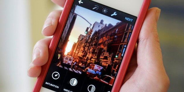 This Monday, June 9, 2014 photo shows the Instagram app, featuring new editing tools, on an iPhone posed for a photo in New York. Instagram, available for iOS 6.0 and later and Android phones, recently introduced 10 new editing tools. (AP Photo/Mark Lennihan)