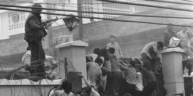 FILE -- Mobs of Vietnamese scale the walls of the U.S. Embassy in Saigon in an effort to get to a helicopter pick up zone as the capital of South Vietnam was falling to North Vietnamese forces May 1, 1975. Restoring the American diplomatic presence in Vietnam, Secretary of State Warren Christopher will preside over the opening of the U.S. Embassy, this time in Hanoi, the capital of the nation unified in 1975. (AP Photo/Neal Ulevich)