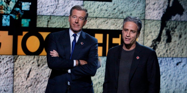 In this photo provided by NBC, Brian Williams, left, and Jon Stewart appear during "Hurricane Sandy: Coming Together" Friday, Nov. 2, 2012, in New York. (AP Photo/NBC, Heidi Gutman)