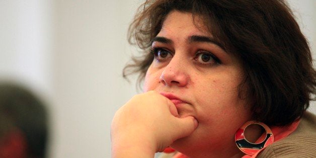 This photo taken Sunday, March 2, 2014, shows Azerbaijani Khadija Ismayilova, a reporter for Radio Free Europe/Radio Liberty, in Baku, Azerbaijan. Azerbaijan detained Khadija Ismayilova, a prominent investigative journalist, on Friday whose reporting has often featured the business dealings of top politicians in the country. (AP Photo/Aziz Karimov)