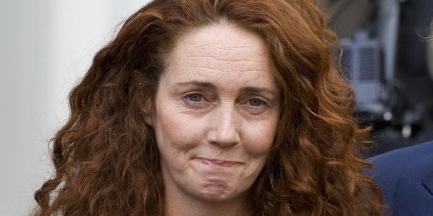 Former Head of News International Rebekah Brooks (L) and her husband Charlie Brooks prepare to give a statement to members of the media in the wake of the phone-hacking trial, in London on June 26, 2014. Former Rupert Murdoch confidante Rebekah Brooks was cleared of all charges in a dramatic end to Britain's marathon media trial on Tuesday June 24, 2014. AFP PHOTO / JUSTIN TALLIS (Photo credit should read JUSTIN TALLIS/AFP/Getty Images)