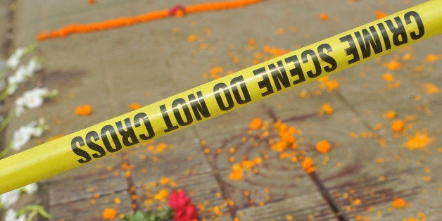 DHAKA, BANGLADESH - 2015/02/27: The spot of the murder marked with large dry pool of blood is cordon off by police. Blogger Avijit Roy who was known for his writing against religious fundamentalism was hacked to death by unknown attackers, died late Thursday night after he was taken to Dhaka Medical College Hospital . Hundreds of students, teachers and anonymous citizens rally outside Dhaka University to protest against the brutal death of the US blogger of Bangladeshi origin Avijit Roy. (Photo by Mohammad Asad/Pacific Press/LightRocket via Getty Images)