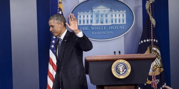 US President Barack Obama leaves after speaking at a press conference in the briefing room of the White House December 19, 2014 in Washington, DC. Obama addressed the press before traveling with the first family on their annual Christmas beach vacation in the president's birth state of Hawaii. Obama on Friday warned North Korea it would face retaliation over a cyber attack on Sony Pictures and pledged not to bow to dictators, as an envoy for Pyongyang denied involvement. AFP PHOTO/BRENDAN SMIALOWSKI (Photo credit should read BRENDAN SMIALOWSKI/AFP/Getty Images)