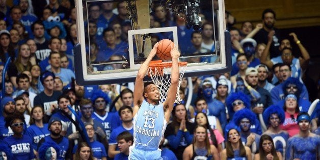 University of North Carolina player J.P. Tokoto does a reverse slam during the Duke game against the University of North Carolina February 18, 2015 at Duke University in Durham, North Carolina. The play quieted the usally loud Dukies and gave the momentum to UNC. The much anticipated game went on to be a thriller with Duke defeating UNC 92-90 in overtime. AFP PHOTO/DON EMMERT (Photo credit should read DON EMMERT/AFP/Getty Images)