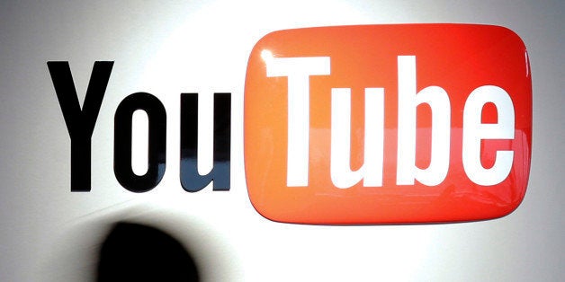 A woman walks past Google Inc.'s YouTube logo displayed at the company's YouTube Space studio in Tokyo, Japan, on Saturday, M
