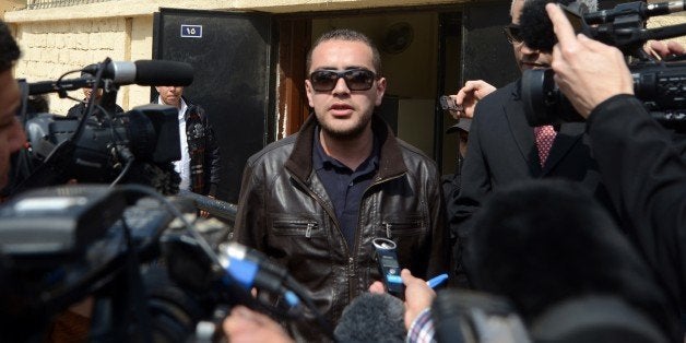 Al-Jazeera's Egyptian producer Baher Mohamed answers journalists' questions as he leaves an Egyptian court after his retrial