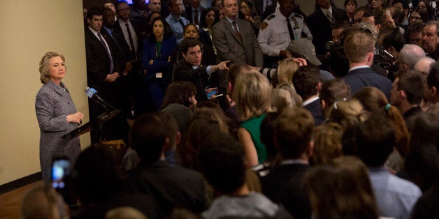 An aide selects a reporter to ask Hillary Clinton, former U.S. secretary of state, left, a question during a news conference at the United Nations (UN) in New York, U.S., on Tuesday, March 10, 2015. Clinton defended the legality of her use of a private e-mail account and server while she served as secretary of state, saying that she had done so out of a desire for convenience but should have used a government account for work purposes. Photographer: Victor J. Blue/Bloomberg via Getty Images