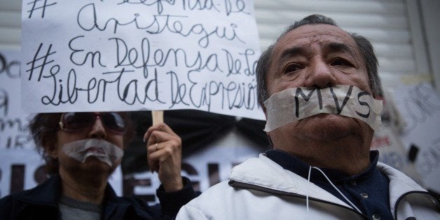 MEXICO CITY, MEXICO - MARCH 16: People attend a protest to support Carmen Aristegui outside the media chain MVS, where she worked, in Mexico City, Mexico on March 16, 2015. Carmen Aristegui, one of the foremost opinion leaders and journalists in Mexico, had a conflict with the administration that may have ended her career. Her research team was the one who brought to light the case of the 'White House' of President Enrique Pena Nieto. (Photo by Manuel Velasquez/Anadolu Agency/Getty Images)