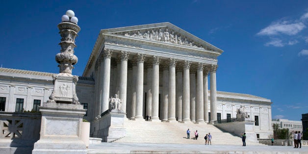 FILE - In this April 26, 2014 file photo, people walk on the steps of the U.S. Supreme Court in Washington. The Supreme Court said Monday that prayers that open town council meetings do not violate the Constitution even if they routinely stress Christianity. (AP Photo/Jacquelyn Martin)