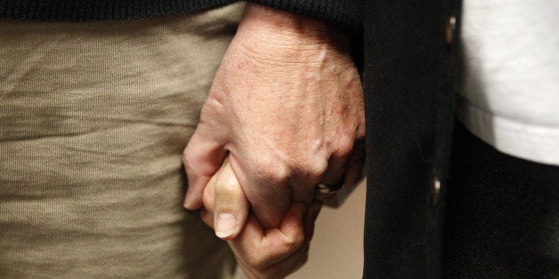 SALT LAKE CITY, UT - OCTOBER 6: Suzanne Marelius, (R) and Kelli Frame, (L) hold hands as they wait in line at the Salt Lake County Recorders Office to get a marriage license on October 6, 2014 in Salt Lake City, Utah. Marelius and Frame are the first same sex couple in Utah to get a marriage license after the U.S. Supreme Court declined challenges to gay marriage making it now legal in Utah. (Photo by George Frey/Getty Images