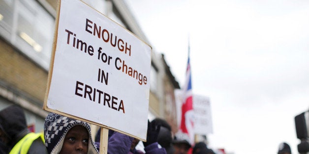 TO GO WITH AFP STORY BY BEATRICE DEBUTEritrean demonstrators hold banners during a protest against the Eritrean regime in central London, on February 22, 2013. Galvanised by the Arab spring, Eritreans in exile in Europe are mobilising against the authoritarian regime of President Issaias Afeworki with a new tool -- the humble telephone. Every week, members of the diaspora make hundreds or even thousands of automated calls to their compatriots in the eastern African nation, chosing their numbers at random and playing them one-minute recorded messages to spread dissent. AFP PHOTO / JUSTIN TALLIS (Photo credit should read JUSTIN TALLIS/AFP/Getty Images)