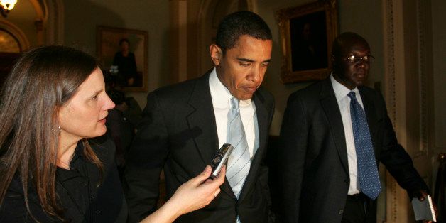 Sen. Barack Obama walks outside Senate Chambers at the U.S. Capitol in Washington, Tuesday, Jan. 16, 2007. Obama announced his intentions to file a presidential exploratory committee on his web site, the initial step in a bid that could make him the nation's first black to occupy the White House. The reporter to his left is Christi Parsons with the Chicago Tribune. (AP Photo/Lawrence Jackson)