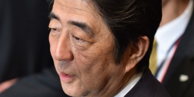 Japanese Prime Minister Shinzo Abe waits for his bilateral meeting with Chinese President Xi Jinping (not pictured) before their bilateral meeting on the sidelines of the Asian Africa Conference in Jakarta on April 22, 2015. The leaders of China and Japan held talks on April 22 for only the second time since taking office, a Japanese official said, seeking to repair a relationship damaged by territorial disputes and a bitter wartime legacy. AFP PHOTO / BAY ISMOYO (Photo credit should read BAY ISMOYO/AFP/Getty Images)