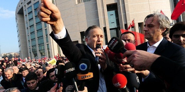 Ekrem Dumanli (C), editor-in-chief of the Zaman newspaper, Turkey's top-selling newspaper, speaks to media after he was relea