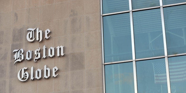 BOSTON, MA - FEBRUARY 20: The Boston Globe signage hangs on the side of its building on February 20, 2013 in Boston, Massachusetts. The New York Times Company, which owns The Boston Globe, said today its plans to sell the Globe and it's New England Media Group, and has hired an investment firm to help manage the sales process. (Photo by Darren McCollester/Getty Images)