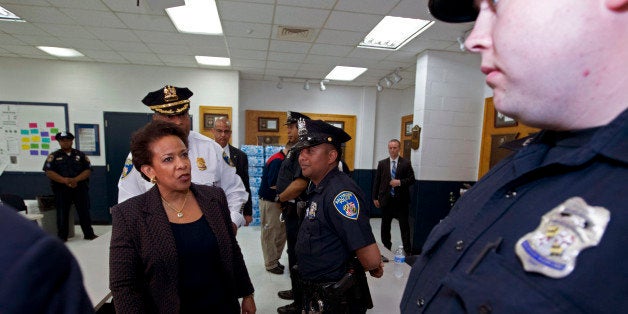 Attorney General Loretta Lynch meets with Baltimore police officers during a visit to the Central District of Baltimore Police Department , on Tuesday, May 5, 2015, in Baltimore. The FBI and the Justice Department are investigating Freddie Gray's death for potential civil rights violations. (AP Photo/Jose Luis Magana, Pool)