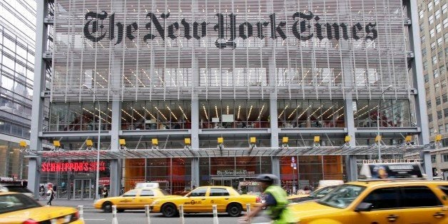 In this Oct. 18, 2011 photo, traffic passes the New York Times building, Tuesday, in New York. The publisher of The New York Times, The Boston Globe and other newspapers said Thursday, Oct. 20, 2011 that it earned $15.7 million, or 10 cents per share, in the July-September period. Thatâs up from a net loss of $4.3 million, or 3 cents per share, a year earlier. (AP Photo/Mark Lennihan)