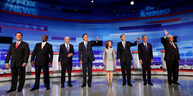 Republican presidential candidates pose for a photo before the start of the Iowa GOP/Fox News Debate at the CY Stephens Auditorium in Ames, Iowa, Thursday, Aug. 11, 2011. Pictured from left to right: former Pennsylvania Sen. Rick Santorum; businessman Herman Cain; Rep. Ron Paul, R-Texas, former Massachusetts Gov. Mitt Romney; Rep. Michele Bachmann, R-Minn.; former Minnesota Governor Tim Pawlenty; former Utah Gov. Jon Huntsman; former House Speaker Newt Gingrich. (AP Photo/Charlie Neibergall)