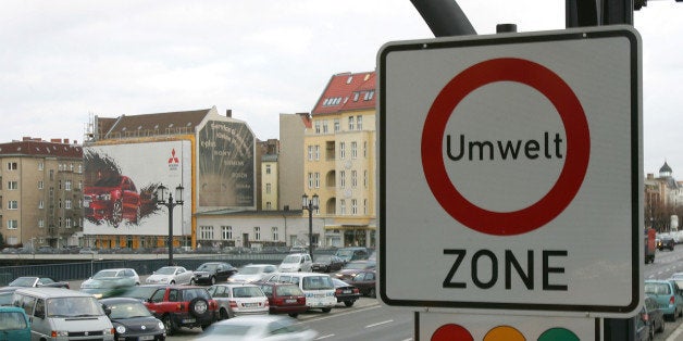 BERLIN - NOVEMBER 27: Cars pass a sign, environmental zone, indicating the new pollution class for cars on November 27, 2007 in Berlin, Germany. Starting from January 1, 2008 Berlin will have an environmental zone which restricts the traffic for high emission vehicles. Being allowed to drive into the inner city you must be in possession of a certain pollutant group sticker. (Photo by Andreas Rentz/Getty Images)