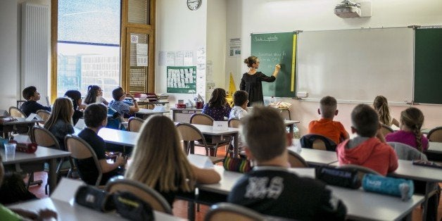 Pupils work in their classroom of a elementary school on September 2, 2014 in Lyon, on the first day of the French new school