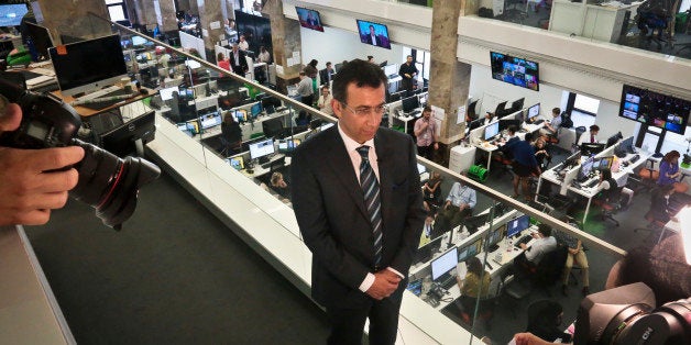 Ehab Al Shihabi, interim CEO for Al-Jazeera America, listens during an interview overlooking the newsroom, after the network's first broadcast on Tuesday, Aug. 20, 2013 in New York. The Qatar-based Al-Jazeera Media Network launched its U.S. outlet only eight months after announcing the new venture, which on Tuesday replaced Al Gore's Current TV in more than 45 million TV homes. (AP Photo/Bebeto Matthews)