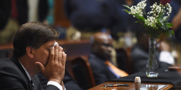 State Senator Vincent Sheheen (D-Kershaw) gets emtional as he sits next to the draped desk of state Sen. Clementa Pinckney, Thursday, June 18, 2015, at the Statehouse in Columbia, S.C. Pinckney was one of those killed, Wednesday night in a shooting at the Emanuel AME Church in Charleston. (AP Photo/Rainier Ehrhardt)